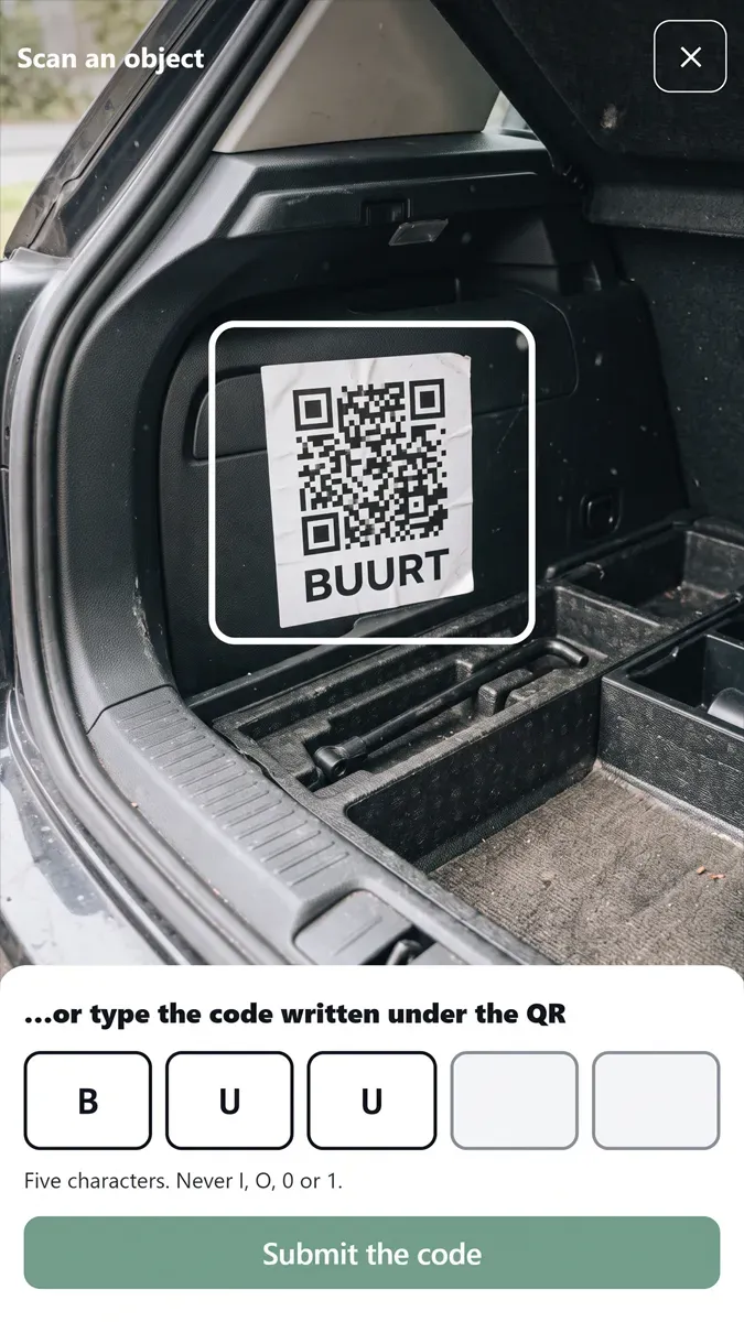 The camera framing a QR label taped inside a car boot; below it, five boxes for typing the code by hand.